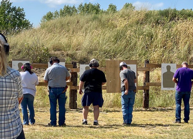 Students reviewing targets during a firearms class