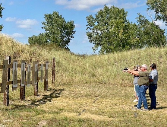 Students receiving supervised firearms instruction at an outdoor range