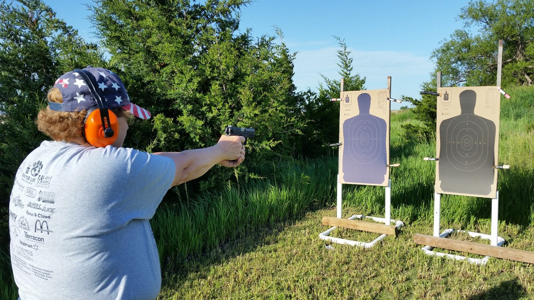 Woman practicing handgun fundamentals at an outdoor range